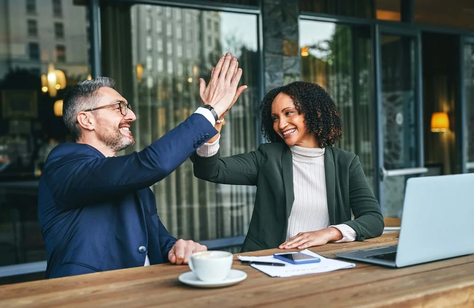 Manager-giving-high-five-to-employee-at-office-favoritism-in-workplace Manager-giving-high-five-to-employee-at-office-favoritism-in-workplace